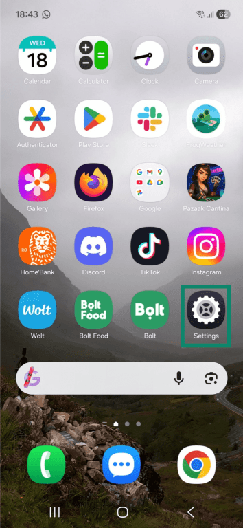 Android phone home screen. The "Settings" app is highlighted.